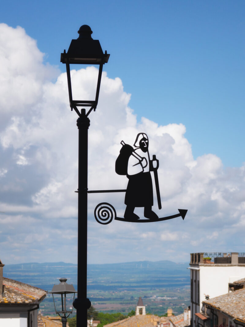 Lampione in ferro con sagoma in silhouette di un pellegrino medievale con bastone a San Martino al Cimino